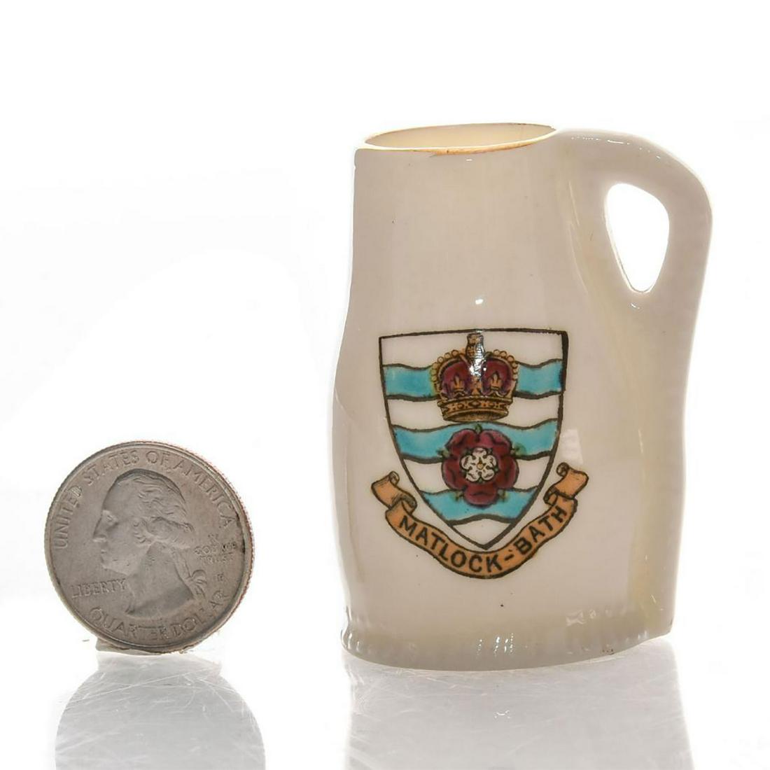 W.H. GOSS MINIATURE CRESTED LEATHER JUG, MATLOCK-BATH: Handpainted Matlock-Bath coat of arms. Bottom base marked MODEL OF LINCOLN JACK THIS JACK WAS THE GIFT OF ALDERMAN BULLEN TO THE COMPANY OF RINGERS. W.H. Goss backstamp. Issued: c. 1930 Dimensions: 2"