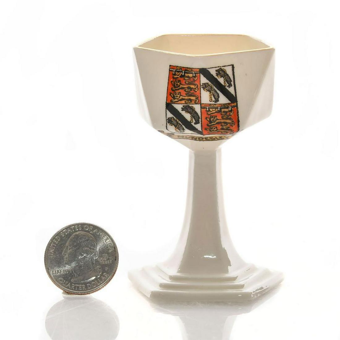 W.H. GOSS MINIATURE CRESTED SALT CELLAR, MUNDESLEY: Marked MODEL OF ANCIENT, SALT CELLAR IN GLASTONBURY MUSEUM. Handpainted Mundesley coat of arms. W.H. Goss backstamp. Issued: c. 1930 Dimensions: 3"H Manufacturer: W. H. Goss Country of Origin: England