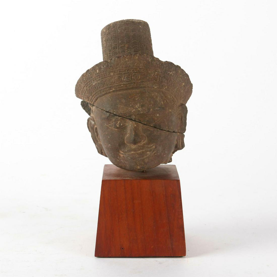 13TH CENTURY CAMBODIAN KHMER STONE SCULPTURE, SHIVA: Bayon style head; carved from stone of rich taupe hues. A large, well made c. 13th century Khmer stone sculptural head modeled as Shiva, one of the principal deities of Hinduism and other faiths. Carv