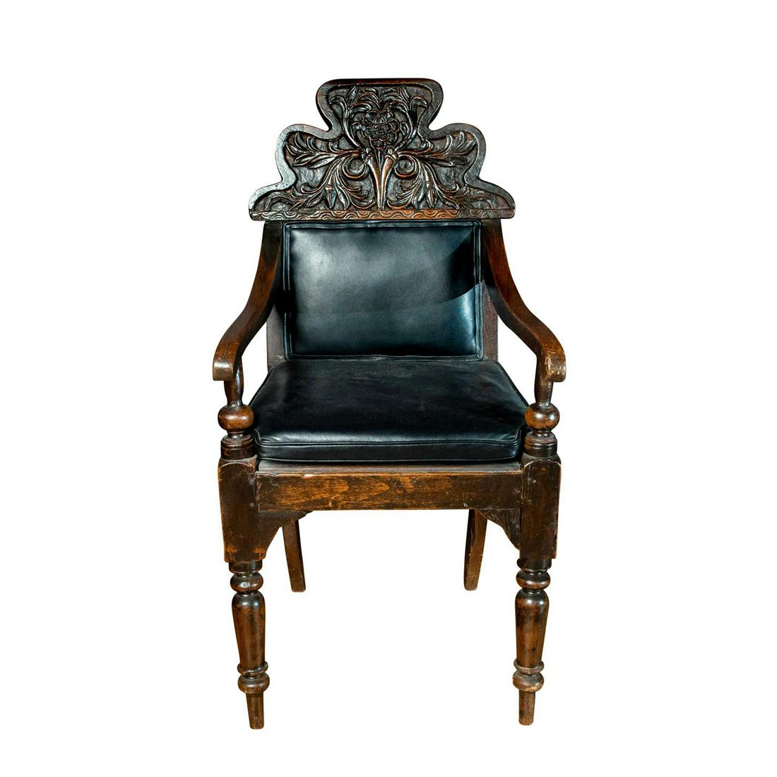 19TH CENTURY RAJ PERIOD COLONIAL WING CHAIR, RANGOON,: Beautifully carved mid-1800s teakwood chair. Leather seat cushion and back rest. Issued: 21st c. Dimensions: 20"L x 21"W x 39"H Country of Origin: Burma Provenance: Collection of John R. Lanzendorf Pr