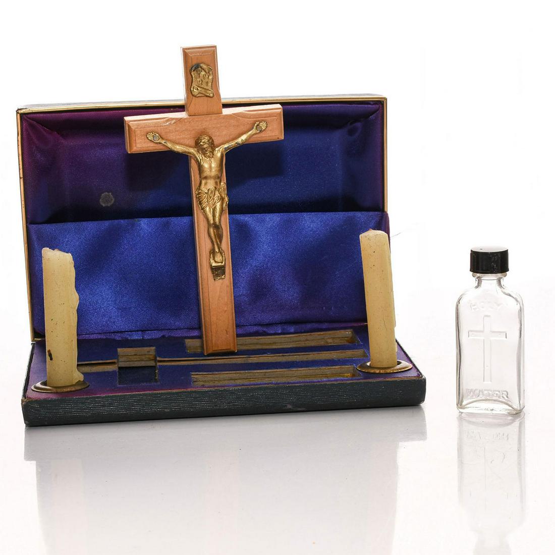 VINTAGE CATHOLIC LAST RITES KIT: Wooden cross with gilt Christ, candles and Holy Water bottle. Issued: 20th c. Dimensions: 1.5"H x 7.5"W Provenance: David Farin Collection