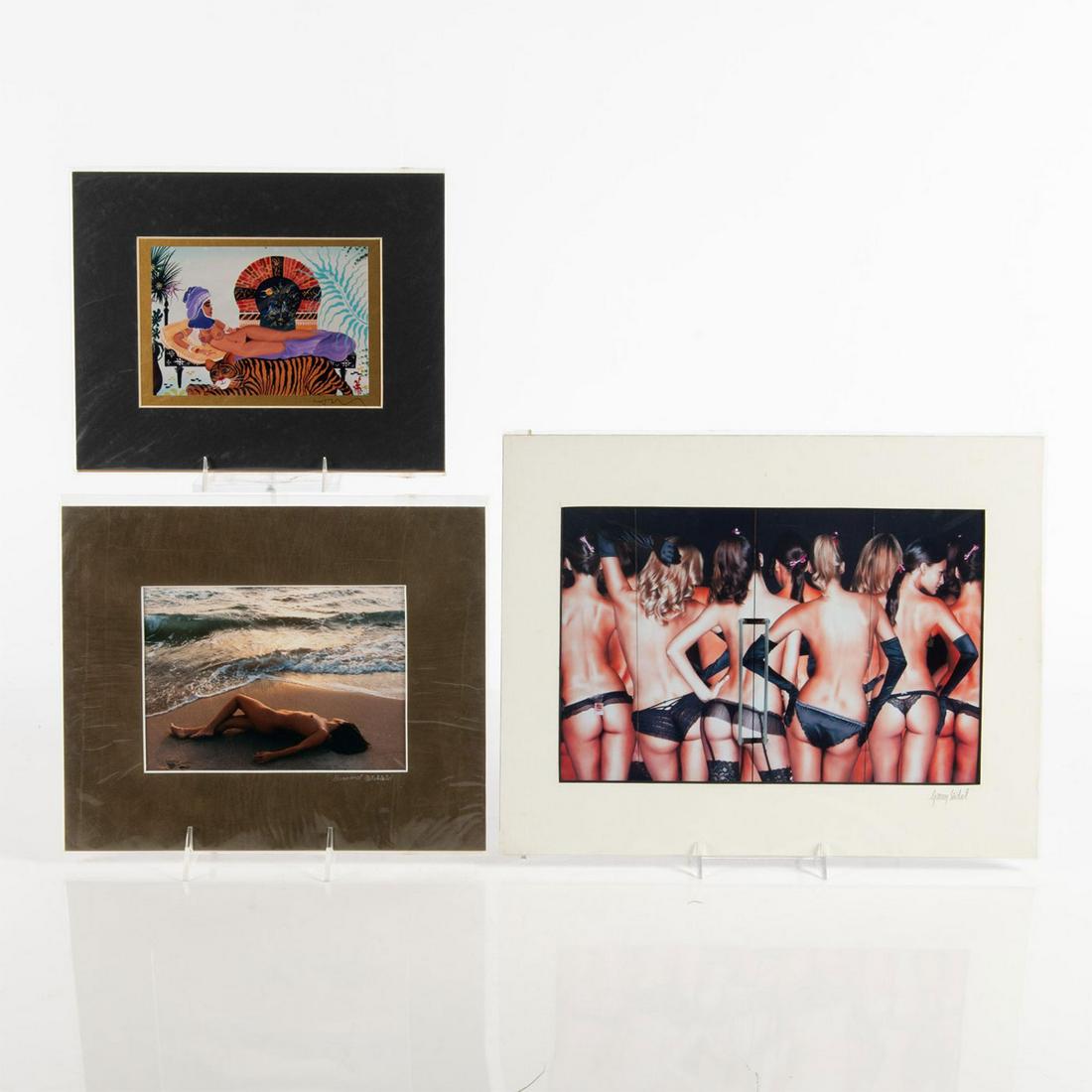 THREE PRINTS OF PHOTOS AND PAINTING, EROTICA: Two color photo and one print of a painting. Color photos The Party by Garry Seidel 11"L x 14"W and female nude at ocean's edge by Bernard Bleckfeld 9"L x 11"W. Print of nude lady reclining with tiger