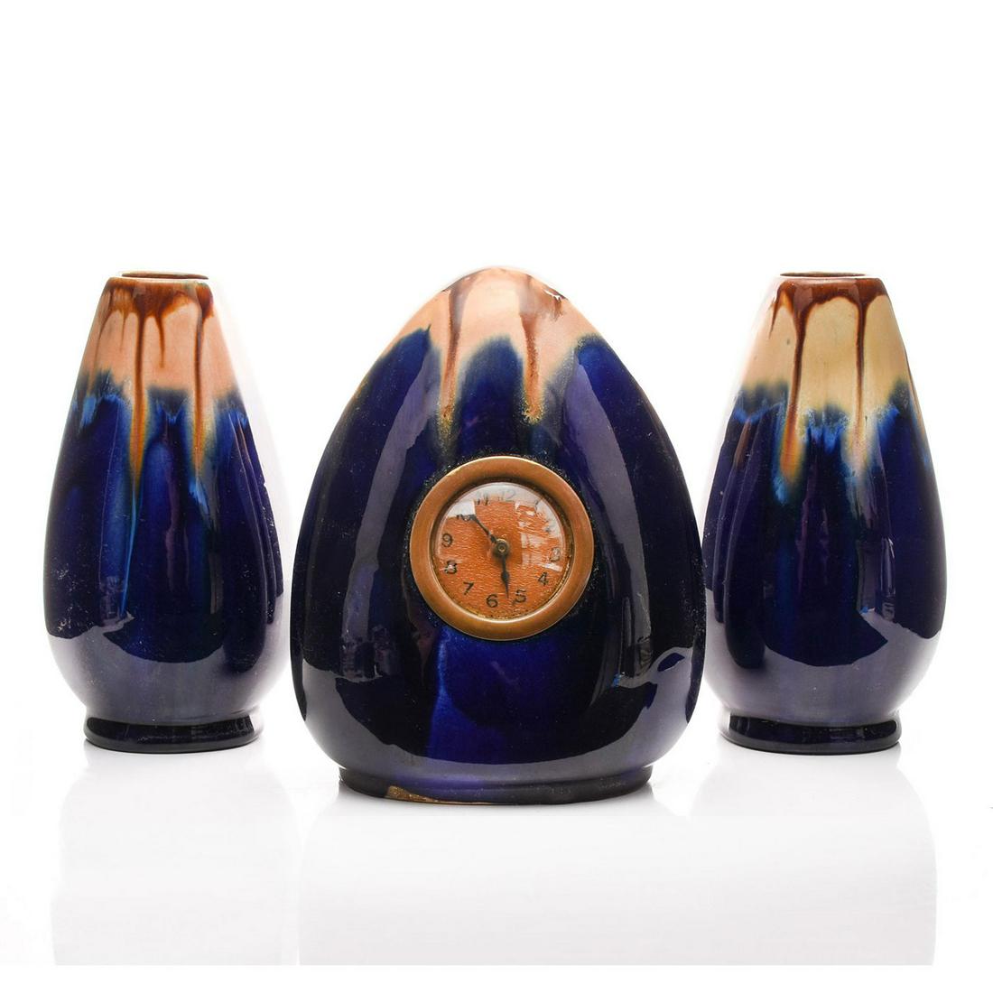 THREE PIECE ART DECO VANITY SET, CLOCK & TWO VASES: Richly glazed cobalt with hand decorated naturalistic colors. Issued: c. 1930 Dimensions: 7.5"H x 6"W, clock Country of Origin: England