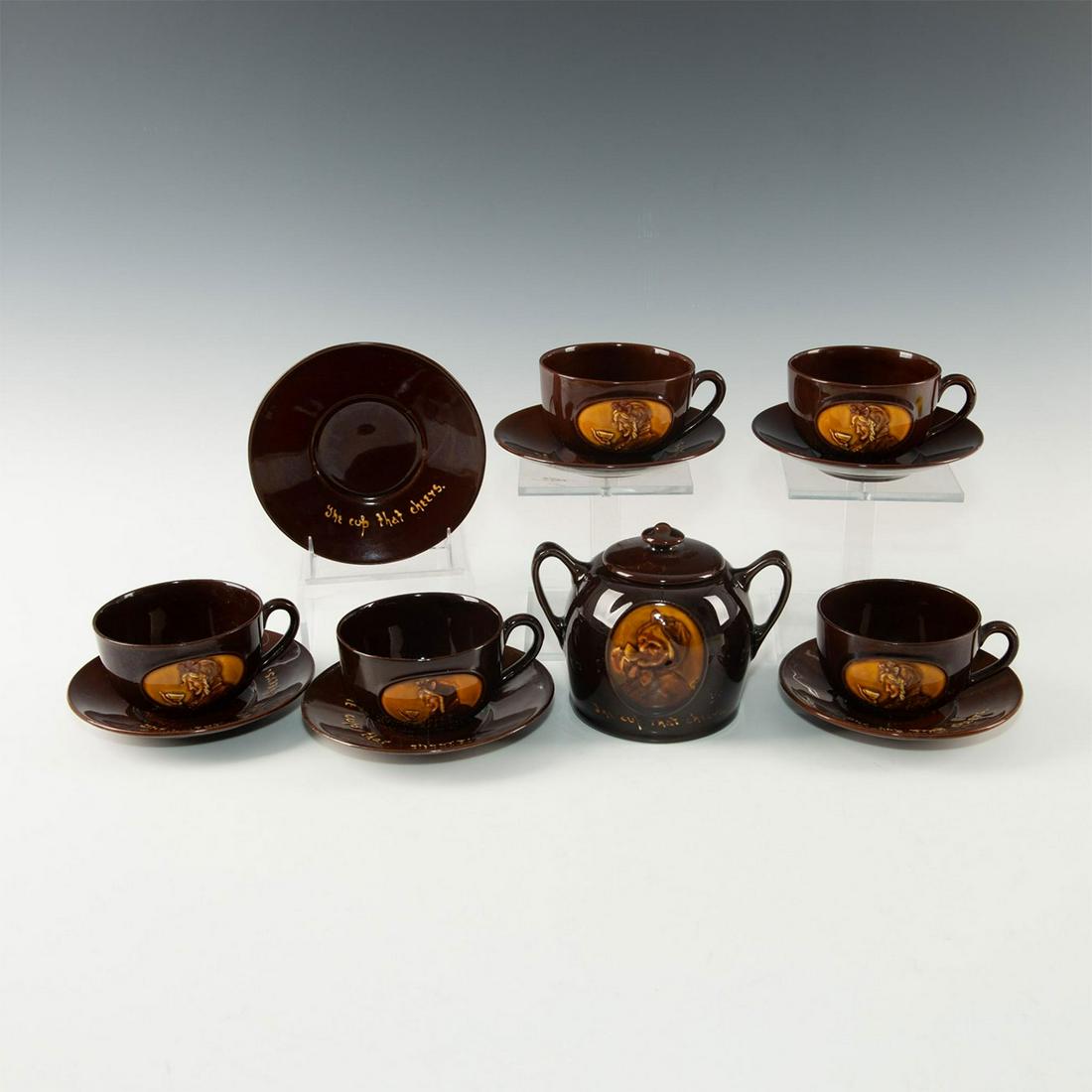 ROYAL DOULTON KINGSWARE TEA SET, "ONE CUP THAT CHEERS": Glazed earthenware with raised relief decoration. Stamped to base. One of Doulton's earliest Kingsware series. Glazed chocolate brown earthenware. Includes double-handled creamer with central decorati