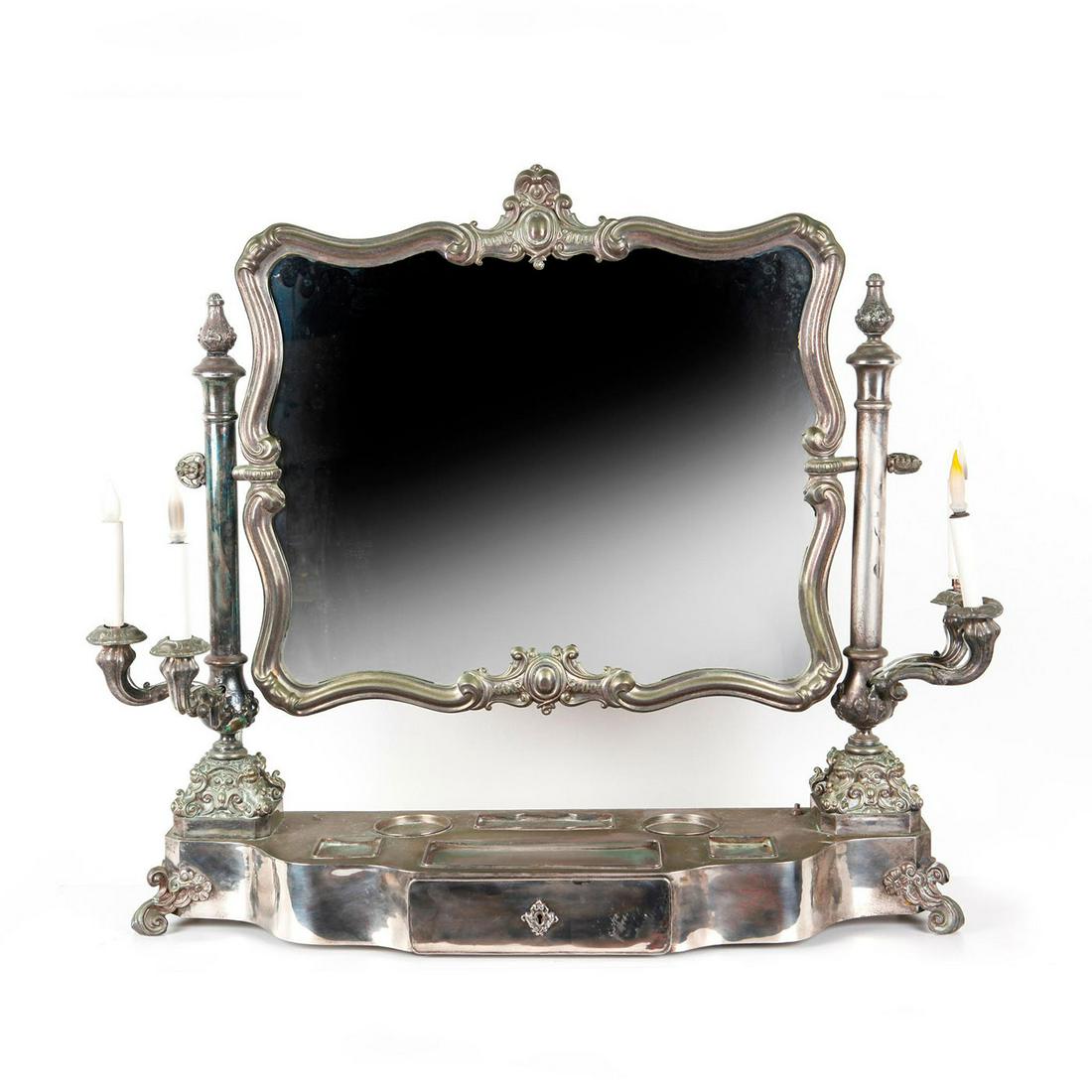 ANTIQUE SILVER VANITY MIRROR, IN THE STYLE OF RUSSIA: Mirror w. stand, drawer, lights. Mirror stand bears a hallmark of St. Petersburg dating to early 18th century, however it has been modified for electric lights. Manufacture possibly dates later than h