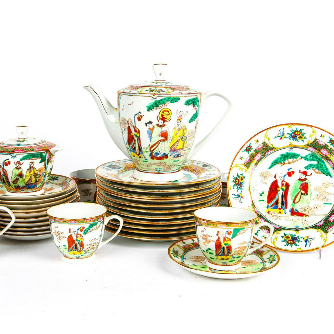 SET OF VINTAGE FAMILLE ROSE GILDED TEA SERVICES.: A set of 12 including tea cups, saucers, creamer and tea pot. Marked HANDPAINTED DECORATION MADE IN CHINA. Painting of the Longevity god on the cups and saucers. And Sanxing on the creamer and teapot.