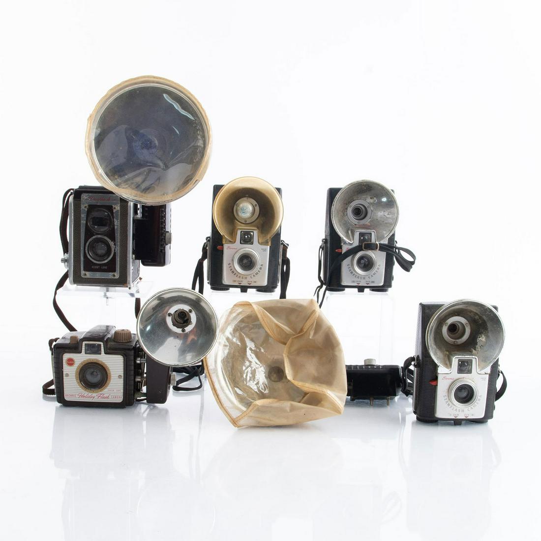 GROUP OF 6 VINTAGE FLASH FILM CAMERAS: Mechanical cameras, bakelite and chrome. Issued: 20th c. Dimensions: 11"L x 9"W, largest