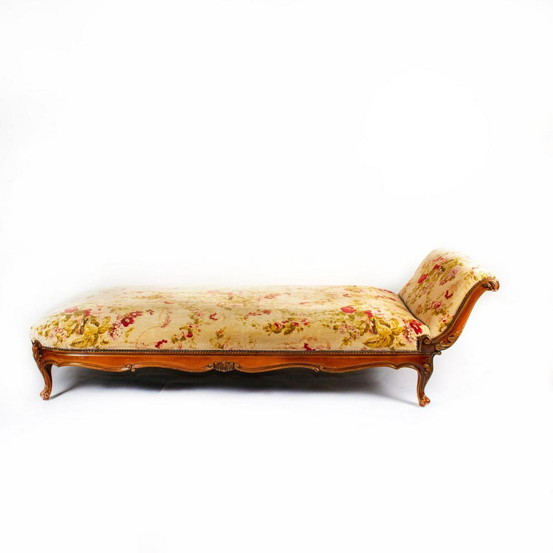 INDOOR PLUSH LOUNGE CHAIR WITH FLORAL UPHOLSTERY: Wood framed wide chair with brass buttons. Issued: 20th c. Dimensions: 80"L x 36"W