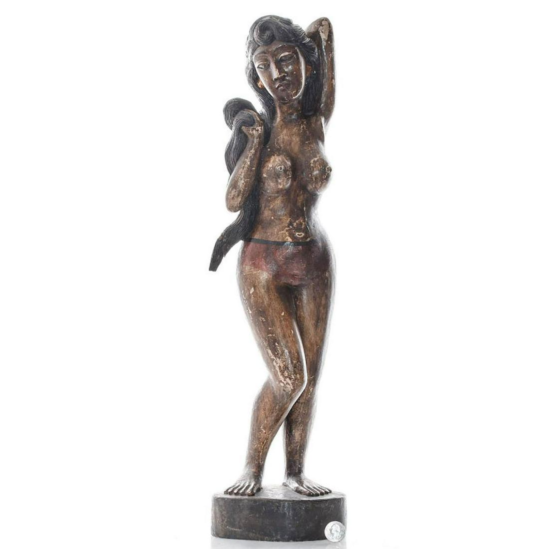 TALL WOODEN INDONESIAN SCULPTURE OF NUDE WOMAN: She is holding her long hair wearing red panties. Issued: 20th c. Dimensions: 24"H Provenance: David Farin Collection