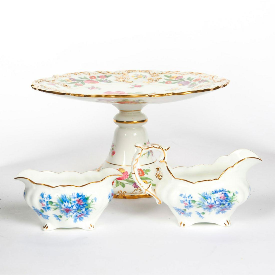 HAMMERSLEY BONE CHINA COMPOTE, CREAMER, SUGAR BOWL: Floral design with gilt detail. Hammersley stamps to bottom. Compote is in the Dresden Sprays pattern, sugar bowl and creamer are in Cornflower Blue pattern. Issued: Early - Mid 20th c. Dimensions: 9"
