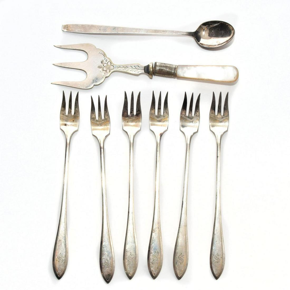 8 VINTAGE SILVER FORKS AND SPOON: 6 W M Rogers oyster forks, Towle iced tea spoon, serving fork. Oyster forks monogrammed with letter S. Hallmarked serving fork, possible mother of pearl handle. Issued: 20th c. Dimensions: 6"H, talles