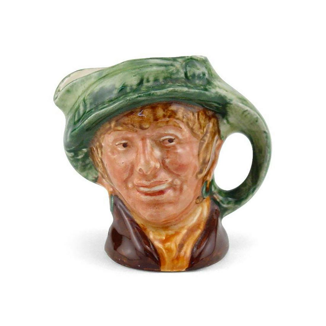 ARRIET D6236 - SMALL - ROYAL DOULTON CHARACTER JUG: Royal Doulton Character Jug, Arriet D6236 (green hat; brown coat; yellow scarf). Designed by Harry Fenton, issued 1947 - 1960. Size: 3.5"H (small) Arriet is a coster of costermonger, a cockney woman w