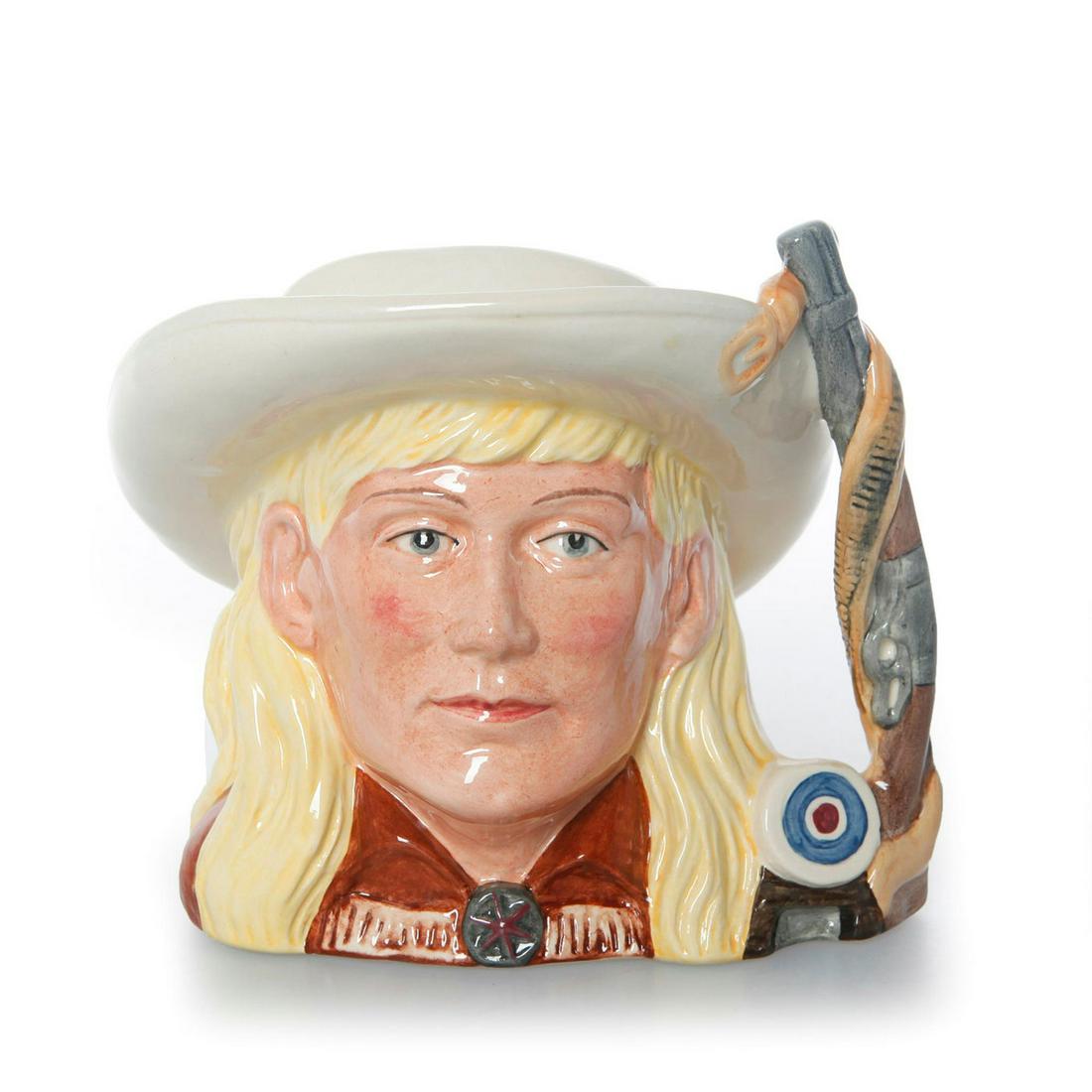 Annie Oakley D6732 - Odd Size - Royal Doulton Character: Part of the Wild West Collection. Royal Doulton backstamp. Artist: Stanley J. Taylor Issued: 1985-1989 Dimensions: 5.25"H Manufacturer: Royal Doulton Country of Origin: England