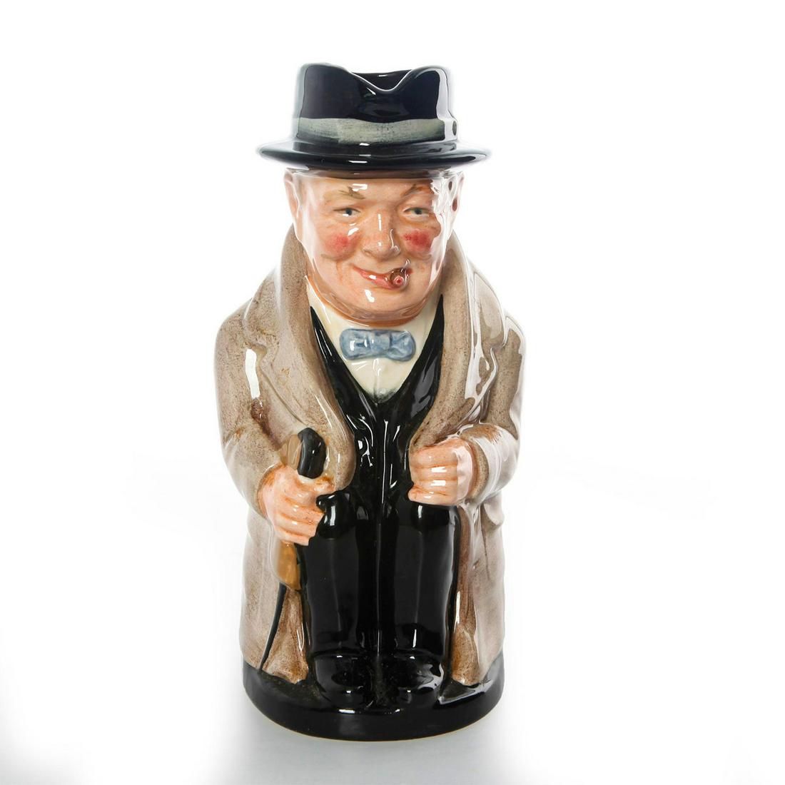 ROYAL DOULTON LG TOBY JUG, WINSTON CHURCHILL D6171: Jug with light brown coat and blue bowtie. Hairline crack to base. Dimensions: 9" Tall Manufacturer: Royal Doulton Country of Origin: England
