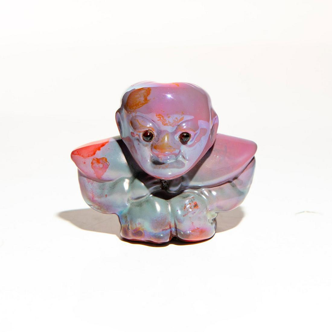 BERNARD MOORE SMALL FIGURE DIAKOKAN GROTESQUE: Figure of a squat form hand painted in lustre pink orange and lavender flambe glaze. Marked Bernard Moore with factory label No. 7 to bottom base. Issued: Early 20th c. Dimensions: 2.25"H Manufacturer