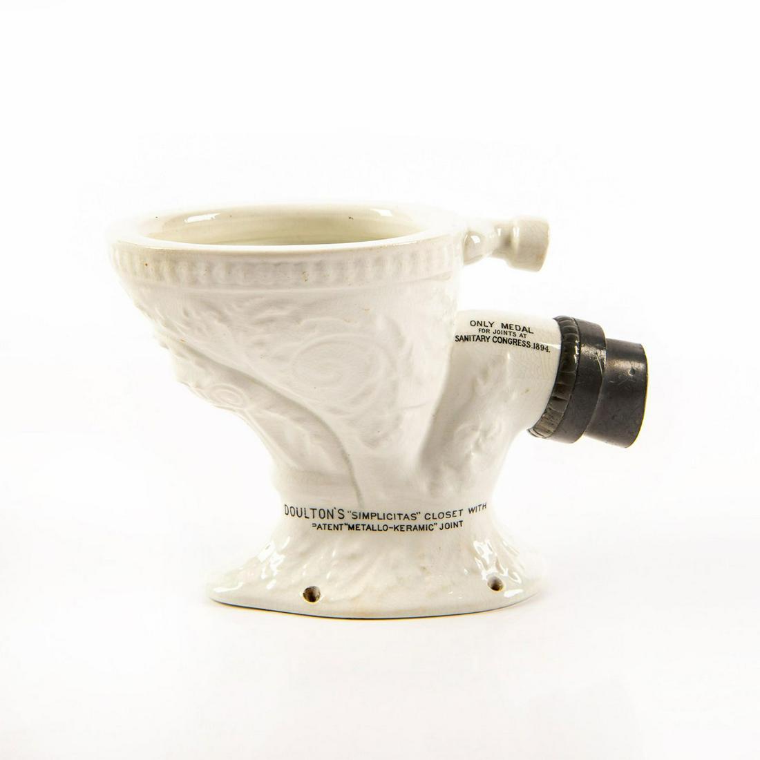 DOULTON SALESMAN SAMPLER SIMPLICITAS WATER CLOSET: Miniature bowl and patented plumbing meant for travelling sales. Made from porcelain and inscribed with Doulton advertising. Inside the bowl the words FITTED WITH "METALLO-KERAMIC" JOINT DOU
