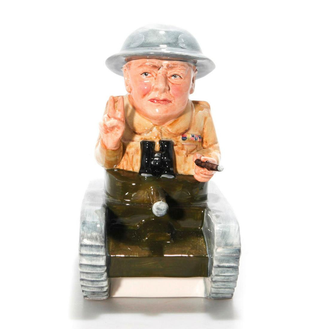 BAIRSTOW MANOR WINSTON CHURCHILL FIGURE TANK COMMANDER: British leader with Victory hand sign. BAIRSTOW MANOR backstamp. Glazed ceramic, Union Jack flag. Churchill with cigar and victory sign. Artist: Ray Noble Issued: c. 1995 Dimensions: 8"H x 8.5"L Manuf