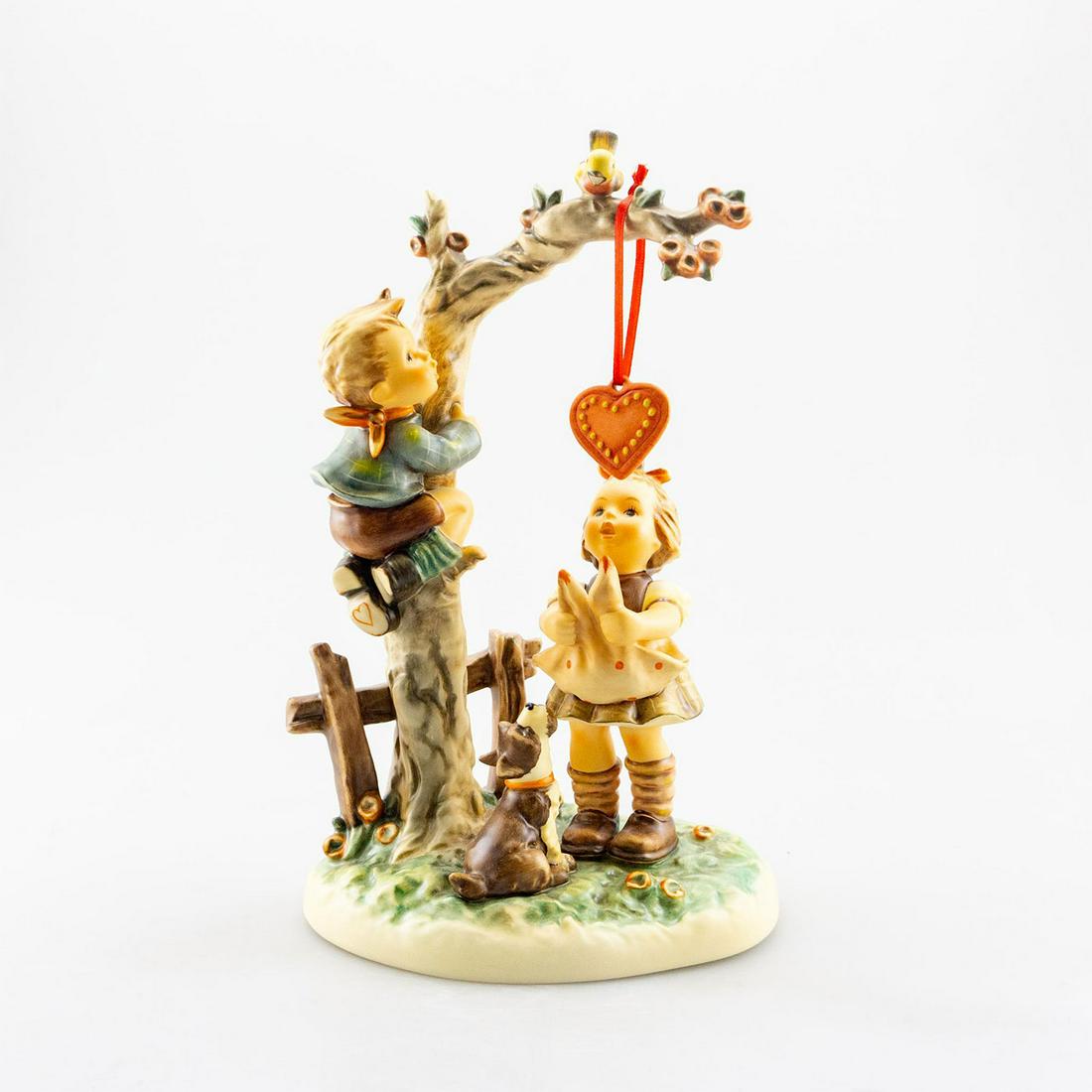 GOEBEL HUMMEL FIGURINE, HERE'S MY HEART 766: Goebel Century Collection figure. Ceramic; Goebel backstamp. Issued: 1998 Dimensions: 10.75"H Manufacturer: Goebel Country of Origin: Germany
