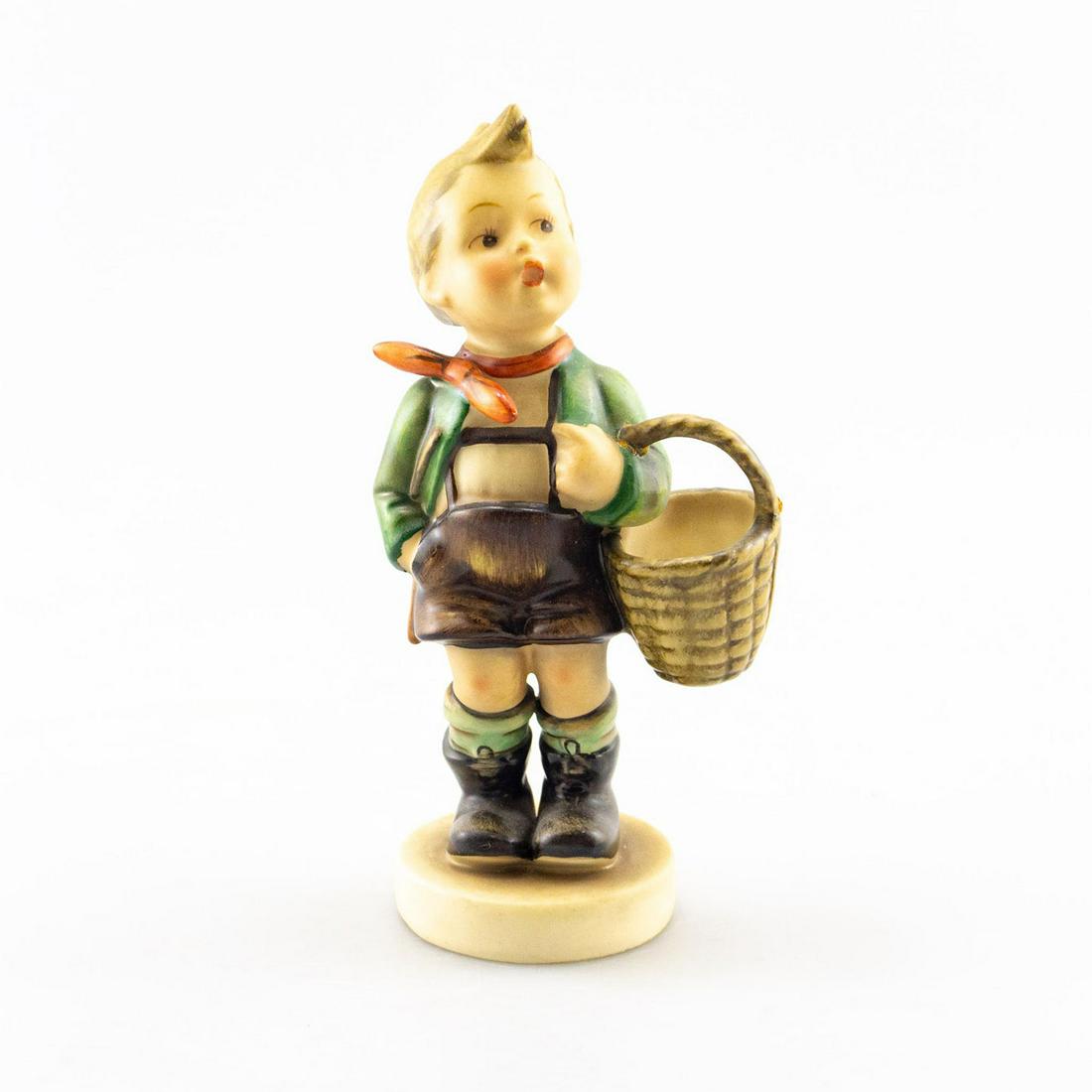 GOEBEL HUMMEL FIGURINE, VILLAGE BOY 51: Handcrafted; hand painted. Boy carrying a basket. Goebel backstamp. Issued: 20th c. Dimensions: 7"H Manufacturer: Goebel Country of Origin: Germany