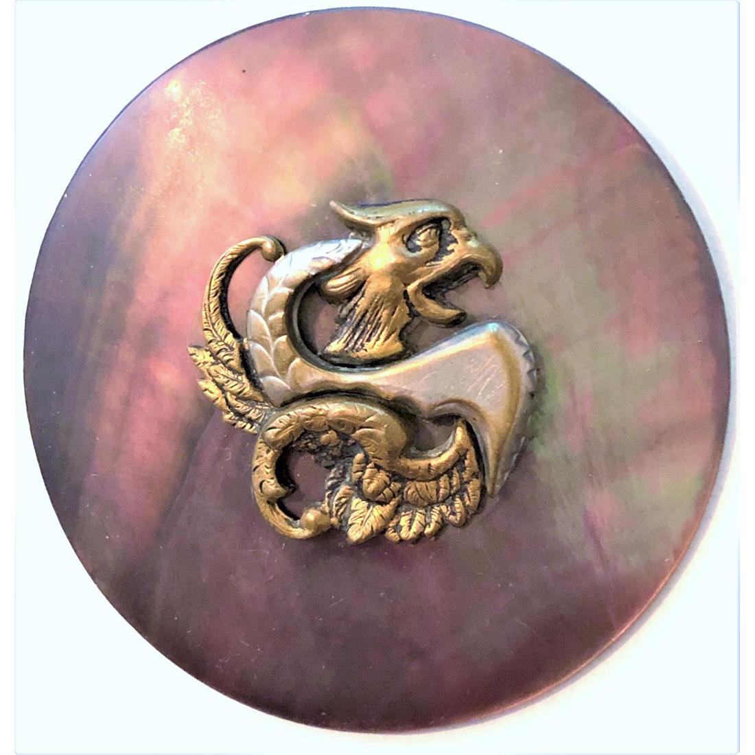 A BEAUTIFUL SHADED DIV. 1 PEARL BUTTON WITH A DRAGON: 1 extra large pink and brown shaded pearl button. This example has an escutcheon in brass and shaped steel of a dragon.