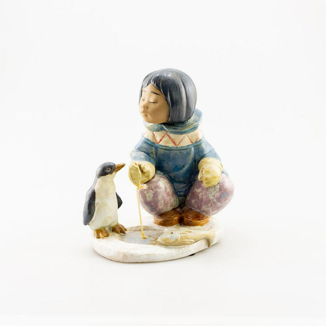 Lladro Figurine, Little Fisherman 2259: Little Eskimo fishing with a penguin. Gres; Lladro back stamp. Issued: 20th c. Dimensions: 8"H Manufacturer: Lladro Country of Origin: Spain Condition: Good