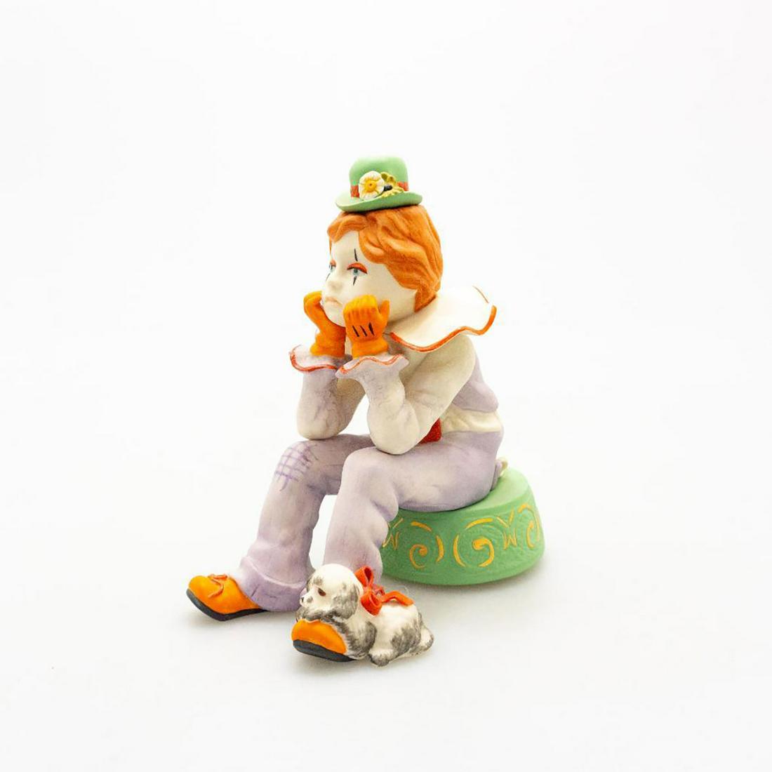 CYBIS PORCELAIN, RUMPLES THE PENSIVE CLOWN: A sad clown sits in deep thought with his little dog resting on his foot. Issued: 20th c. Dimensions: 7"H Manufacturer: Cybis Country of Origin: USA