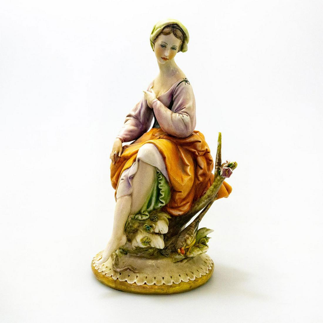 Antonio Borsato Porcelain Figurine, Sylvan Beauty 998: Italian Renaissance style; seated woman in garden. Orange and brown colorway. A. Borsato backstamp. Broken index fingers on both hands. Artist: Antonio Borsato Issued: 20th c. Dimensions: 10"H Country
