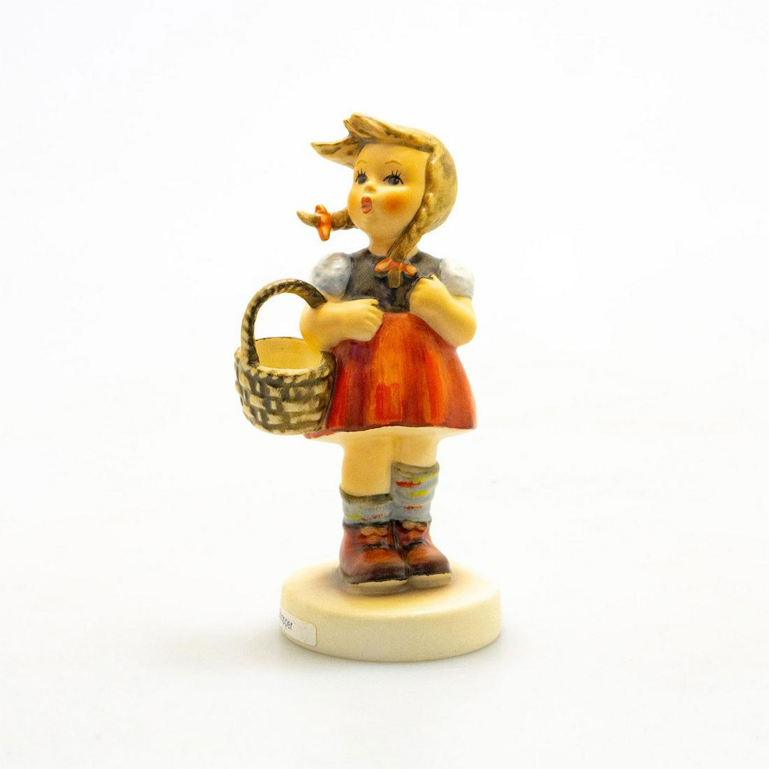 Goebel Hummel Figurine, Little Shopper: Hand painted porcelain, matte finish of a Bavarian girl with basket. Impressed M.I. Hummel to round base. Title label to base. Impressed 96 to bottom base. Goebel backstamp. Marked W. Germany. Artist: