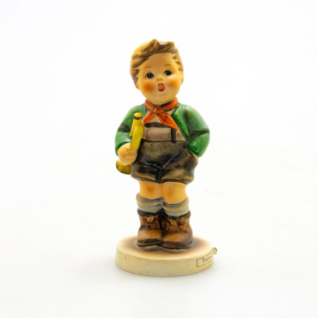 Goebel Hummel Figurine, Trumpet Boy: Hand painted porcelain. Impressed M.I. Hummel to round base. Title label to base. Chipped to bottom base. Impressed 97. Goebel backstamp. Marked W. Germany. Artist: M. I. Hummel Issued: 20th c. Dimens