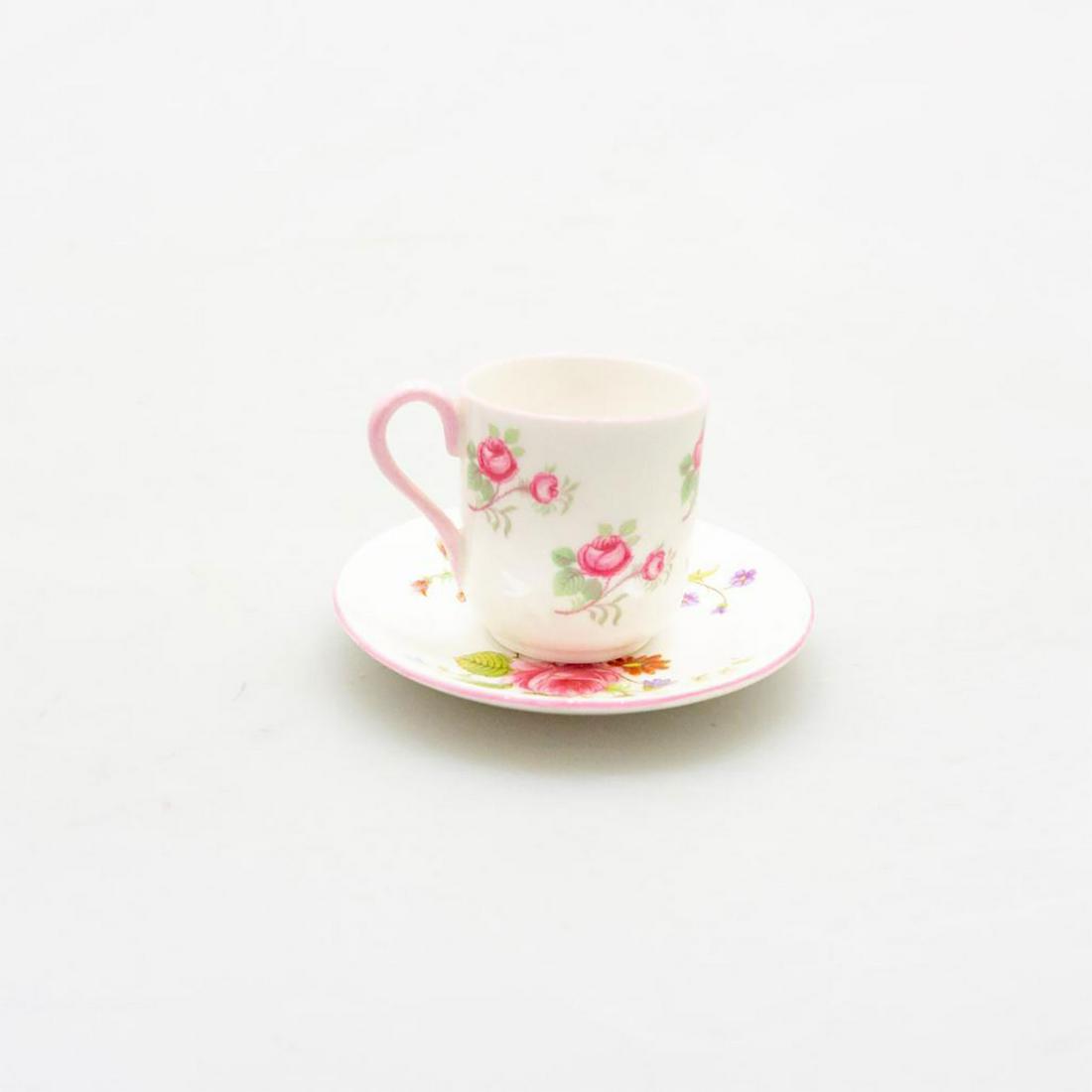 SHELLEY BONE CHINA ART DECO MINI DUO, ROSE & RED DAISY: A group of two, miniature cup and saucer, the latter in Rose and Red Daisy pattern. Glazed eggshell with pink, lavender, red, and green flora. SHELLEY ENGLAND backstamps. #ShelleyBoneChina #BritishCer