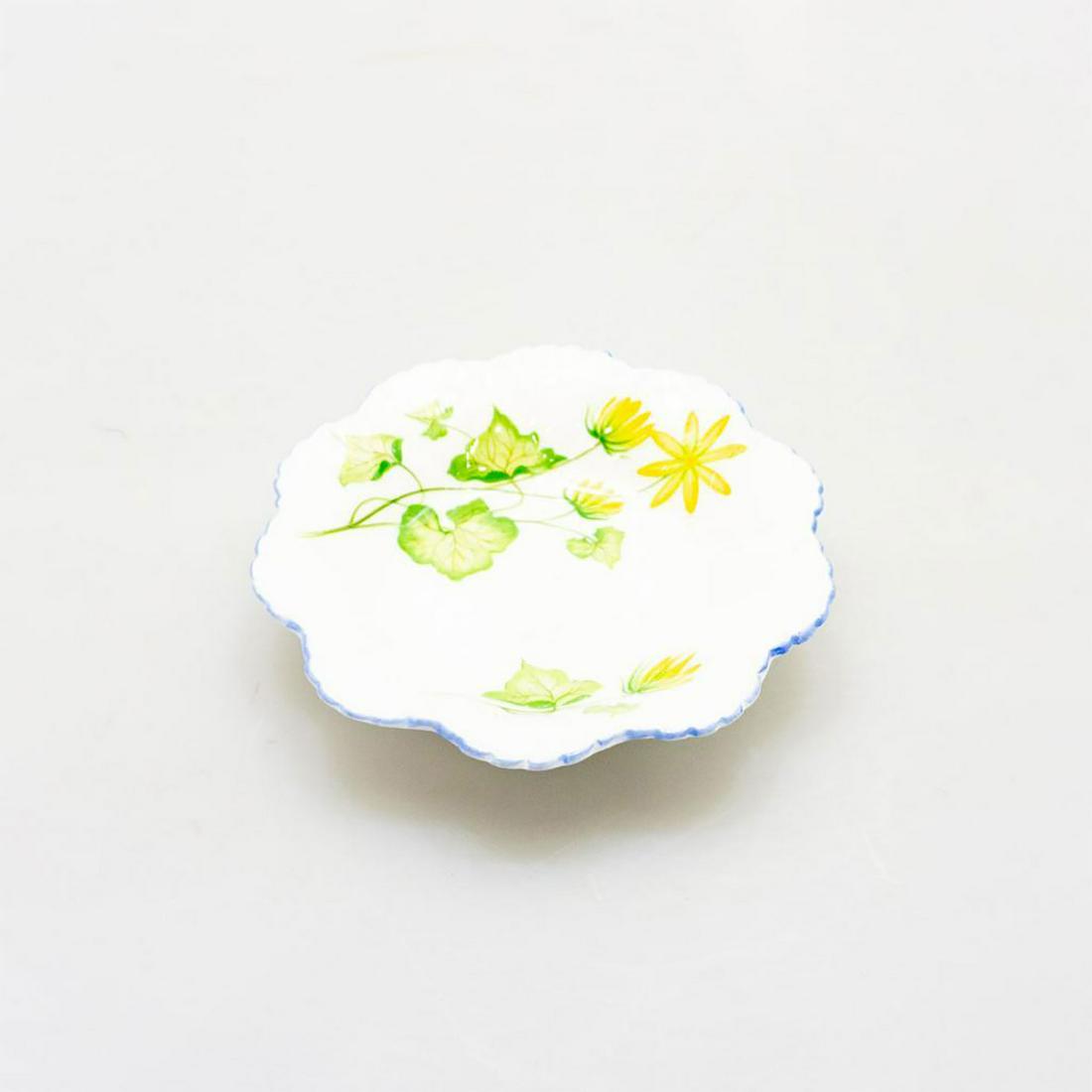 SHELLEY BONE CHINA ART DECO BONBONIERE DISH, CELANDINE: Lustrous glazed ceramic with yellow and green flower, blue trim to edge. An Art Deco Shelley bonboniere pin dish, with colorful yeloow flora decorated in the Celandine pattern. SHELLEY BONE CHINA ENGL