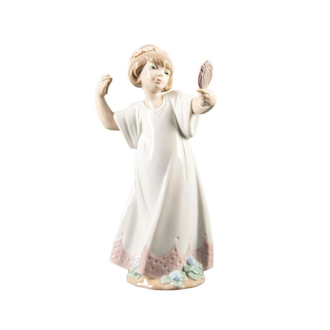 Lladro Child Figurine, Delightful 01006806: Hand painted porcelain; gloss finish. Girl wearing a floral crown looking in a mirror. Lladro backstamp. W. box. Artist: Juan Huerta Issued: 2001- 2004 Dimensions: 9.25"H Manufacturer: Lladro Country 