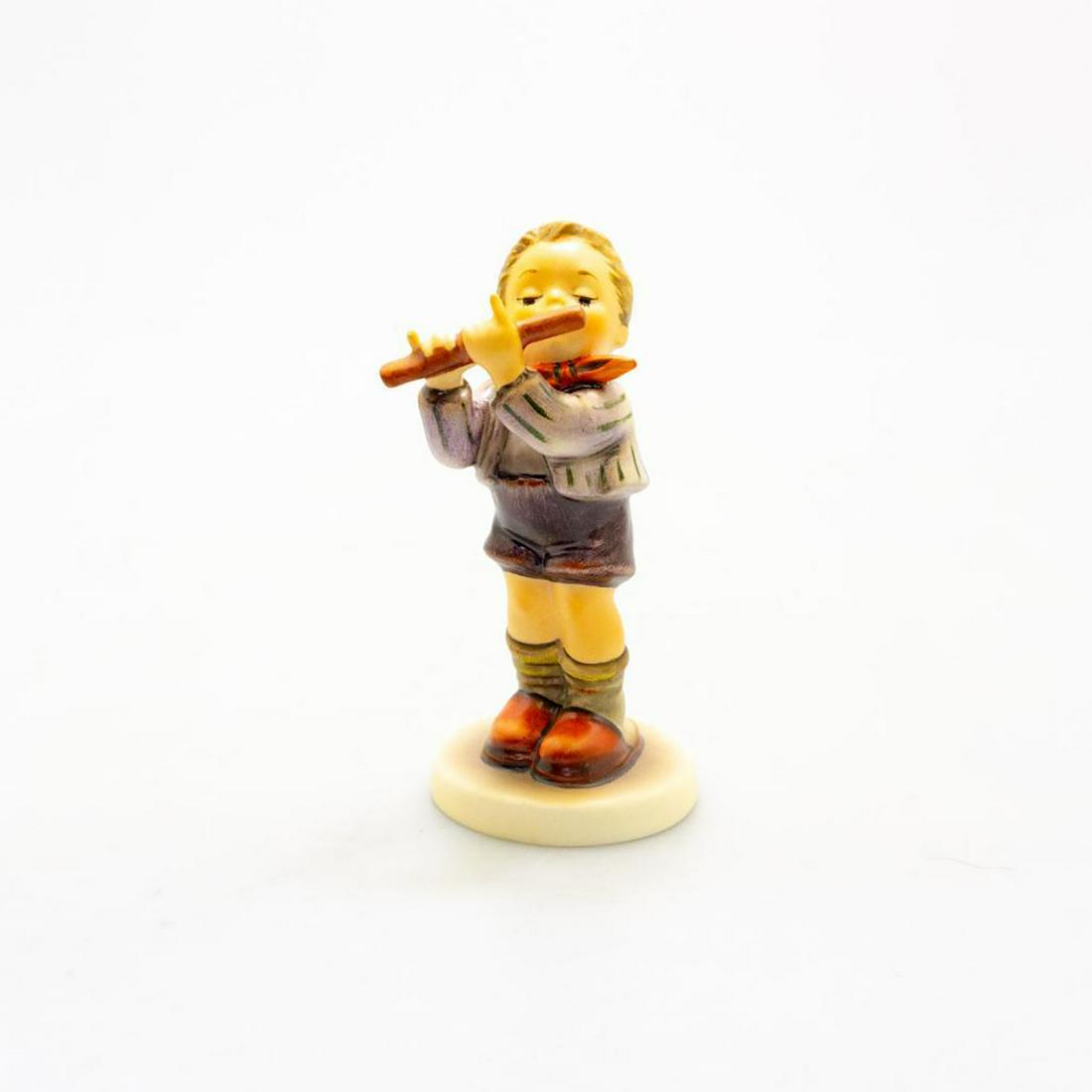 Goebel Hummel Exclusive Figurine, Morning Concert #447: A boy stands playing his flute. Exclusive Special Edition No. 11. Made for members of the Goebel Collector's Club. Issued: 1984 Dimensions: 5.5"H Manufacturer: Goebel Country of Origin: Germany