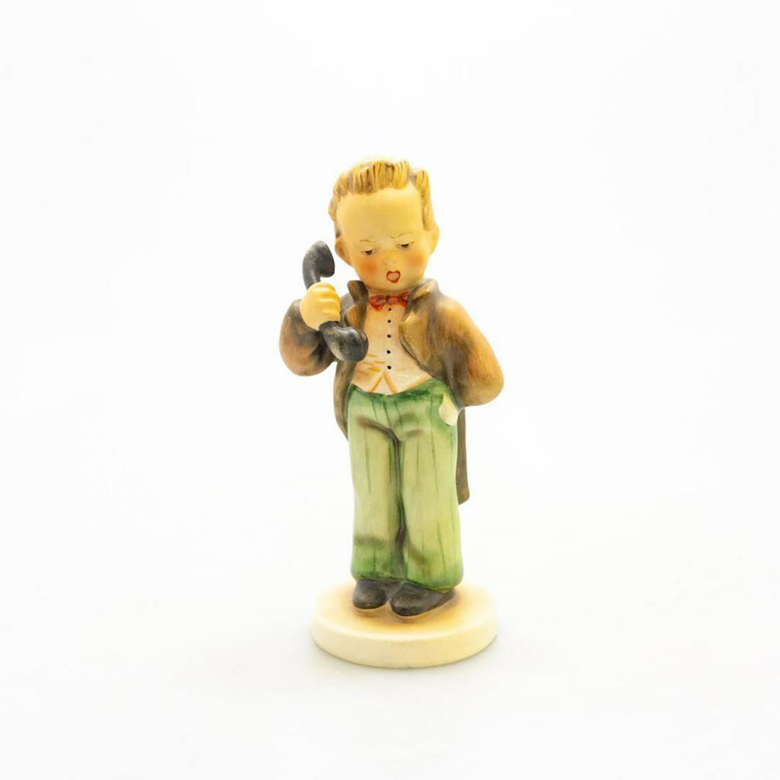 Goebel Hummel Figurine, Hello 124: Young boy holding a phone. Ceramic; handcrafted. Goebel backstamp. Issued: 20th c. Dimensions: 6.25"H Manufacturer: Goebel Country of Origin: Germany