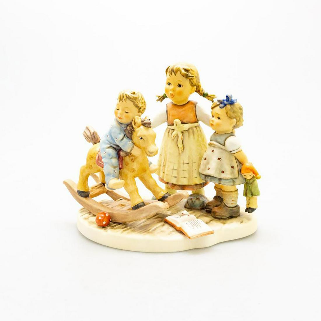 Goebel Hummel Figurine, Learning To Share 2250: The Moments In Time series. Limited edition 1934 of 3000. Young girl pouts as she waits her to turn to ride on the rocking horse. Older sister teaches her younger siblings how to share. Goebel backsta