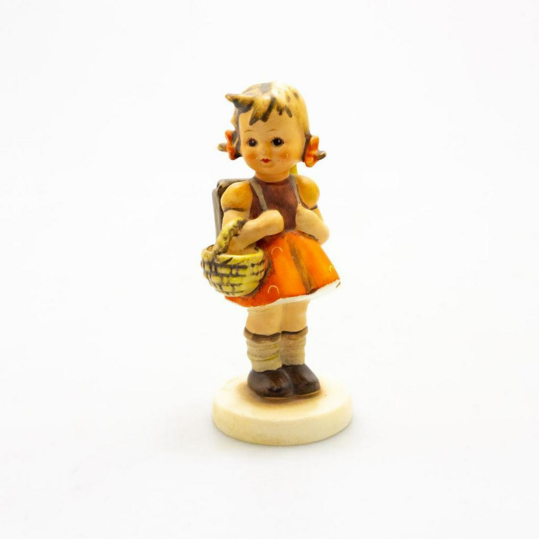 Goebel Hummel Figurine, School Girl #81: A rosy-cheeked school girl wears her backpack and carries a basket. Issued: 20th c. Dimensions: 4.75"H Manufacturer: Goebel Country of Origin: Germany