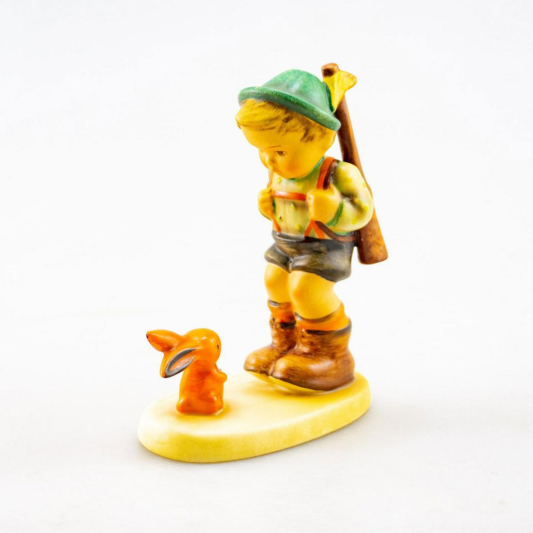 Goebel Hummel Figurine, Sensitive Hunter #6/0: A boy with a musket looks at a rabbit in his bath. Artist: Goebel Issued: 20th c. Dimensions: 5.25"H Country of Origin: Germany