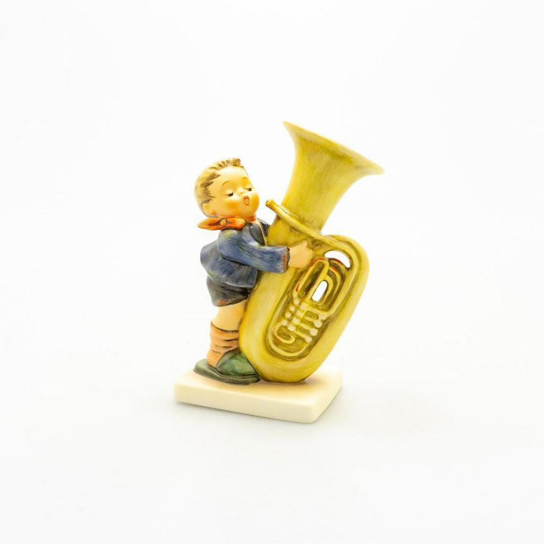 Goebel Hummel Figurine, Tuba Player 437: Young boy playing a tuba. Ceramic; hand crafted; hand painted. Goebel backstamp. Issued: 20th c. Dimensions: 6"H Manufacturer: Goebel Country of Origin: Germany
