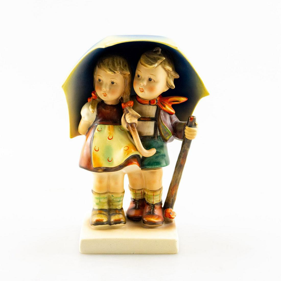 Goebel Hummel Figurine, Stormy Weather #71: Two children retreat under an umbrella. The boy holds a walking stick. Artist: Goebel Issued: 20th c. Dimensions: 6.75"H Country of Origin: Germany
