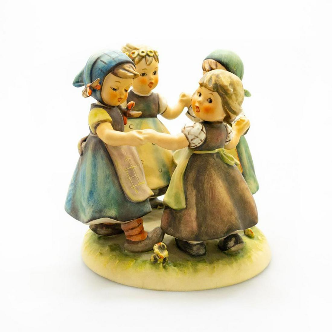 Goebel Hummel Large Group Figure Ring Around The Rosie: Hand painted, featuring four girls playing Ring Around the Rosie. Title label to base. Marked 348 to bottom base. Goebel backstamp. Issued: 1957 Dimensions: 7"H Manufacturer: Goebel Country of Origin: