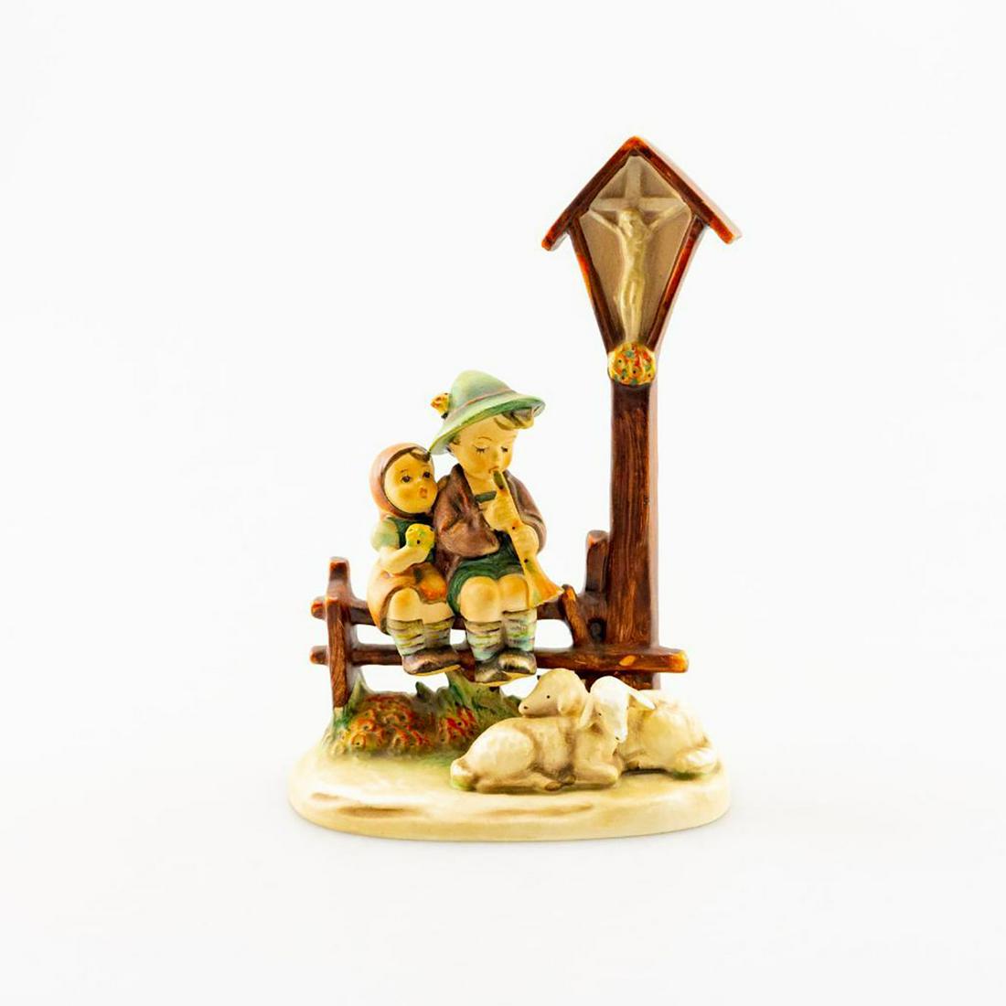 Goebel Wayside Devotion Hummel Figure 28/Ii: This is a vintage "Wayside Devotion" Goebel Hummel Figurine from the 70's. This figurine features a young boy and girl sitting atop a fence with two sheep by their side as well a Jesus shrine box abov