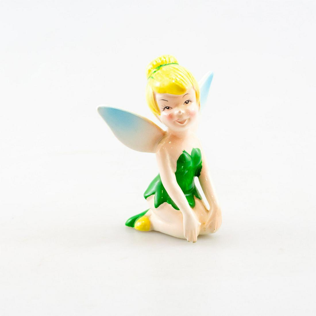 Walt Disney Ceramic Figurine, Tinker Bell: Tinker Bell sits resting on her legs. Made in Japan. Issued: 20th c. Dimensions: 4.5"H Country of Origin: Japan