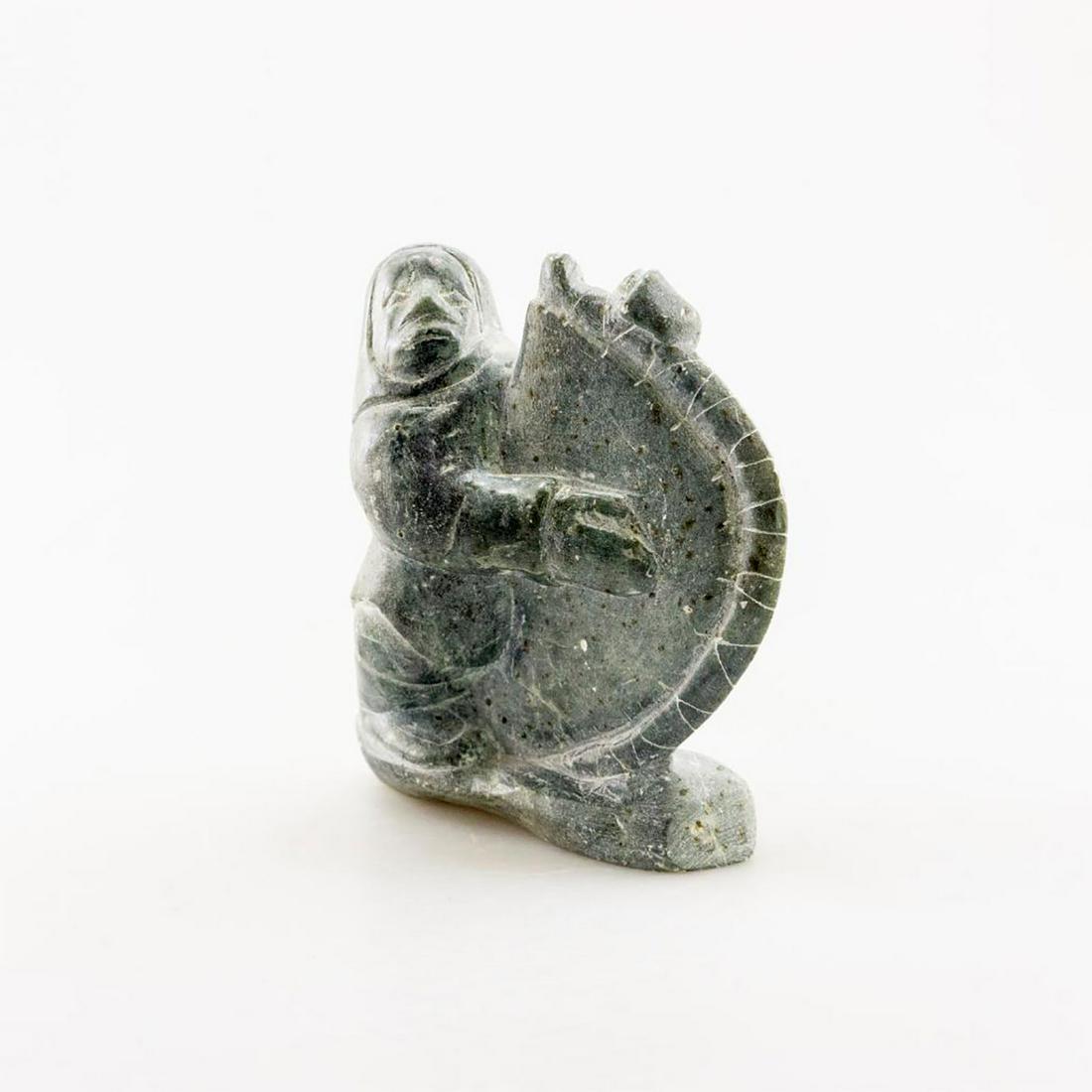 Inuit Soapstone/Regional Stone Figurine Sculpture, Man: Hand carved gray stone with inclusions, artist signed and dated. Vintage patina in striking gray stone, carved in a naturalistic style, an Inuit smoothing an animal hide. #Sculpture #InuitCarving #Inu