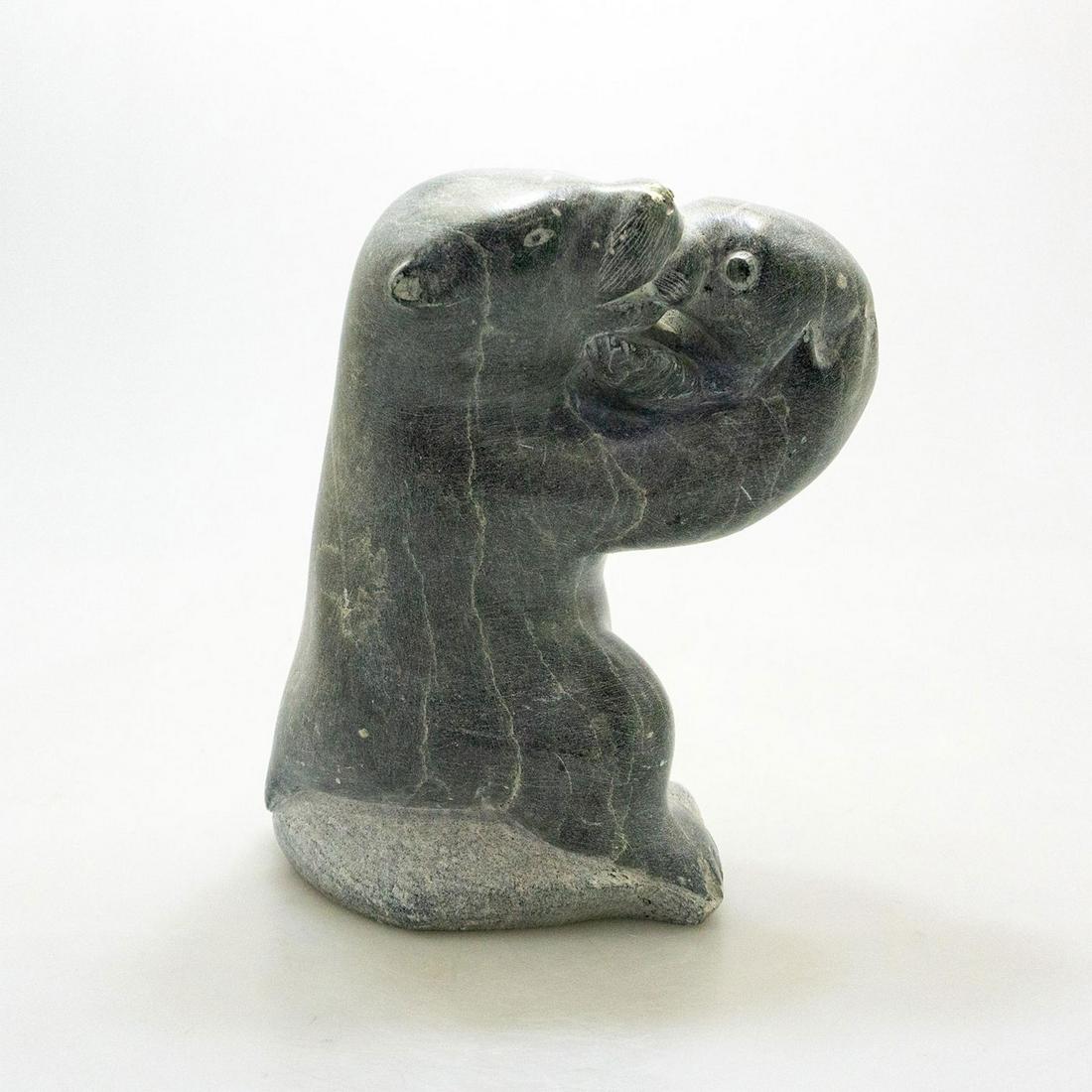 Inuit Tribal Soapstone/Regional Stone Figural Sculpture: Dark gray stone with light patina, in a naturalistic style. Artist signed. Arctic life is captured in realistic manner, in this gray soapstone figural group, artist signed, depicting an arctic bear an