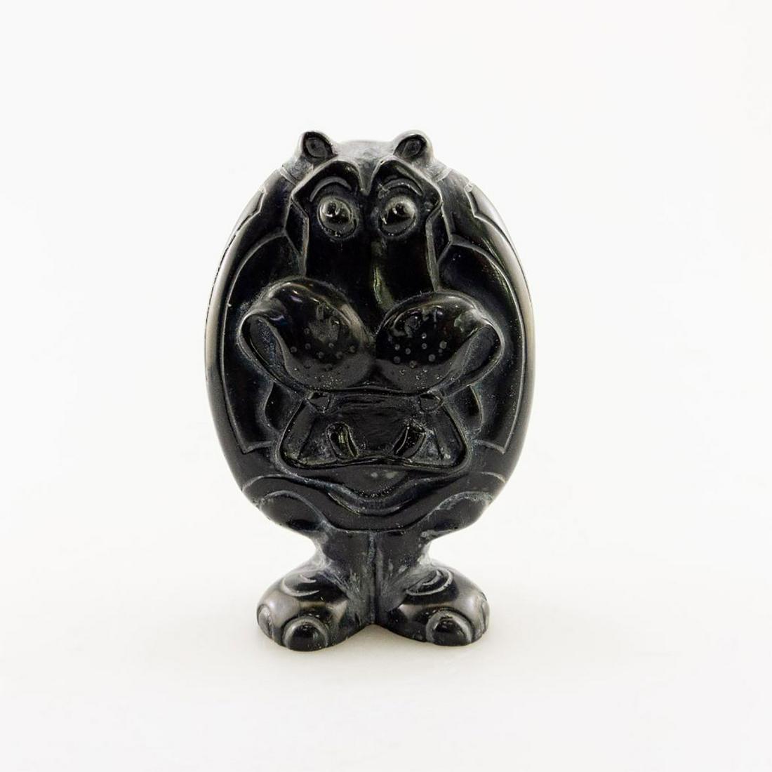 African Soapstone/Regional Stone Figurine Sculpture: Hand carved black stone with whimsical facial traits. Artist signed. Carved from rich, dark lustrous stone. #AfricanArt #Soapstone #Serpentine #Serpentinite #AfricanCarving Issued: c. 1990 Dimensions: