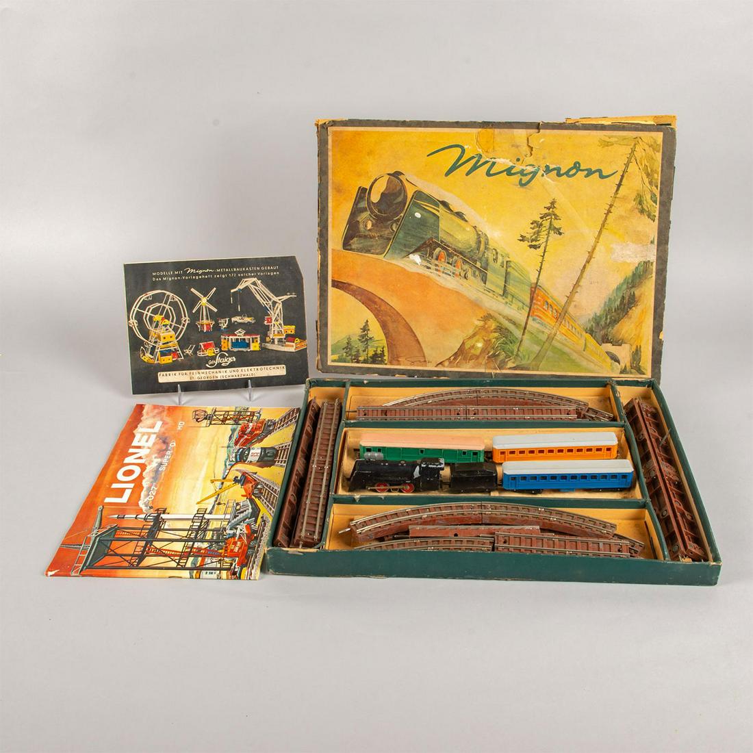 1947 Staiger Mignon Electric Model Toy Train Set: Electric model railway scale of 1:140 with 10mm gauge track. Includes 5 trains with original box. Age related wear to box and train; untested. Issued: 1947 Dimensions: 12"L x 16"H