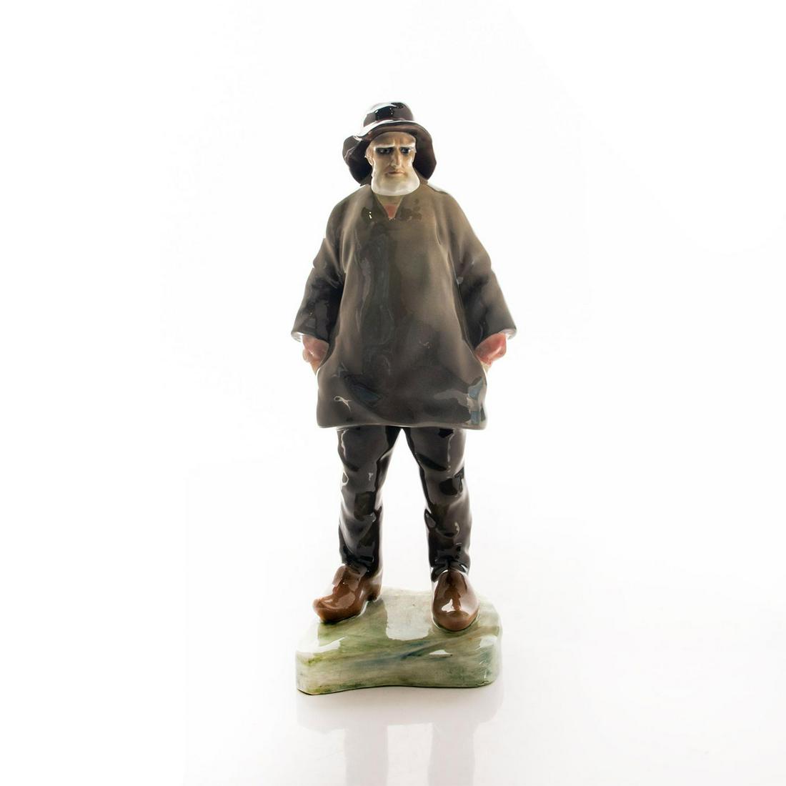 Goldscheider Fisherman Porcelain Figurine: Outstanding figurine of an old man with white beard in gray and brown. He wears sea captain hat and Holland wooden clogs. Signed Hofner on the base. Condition is good. Small chip on the front of the h