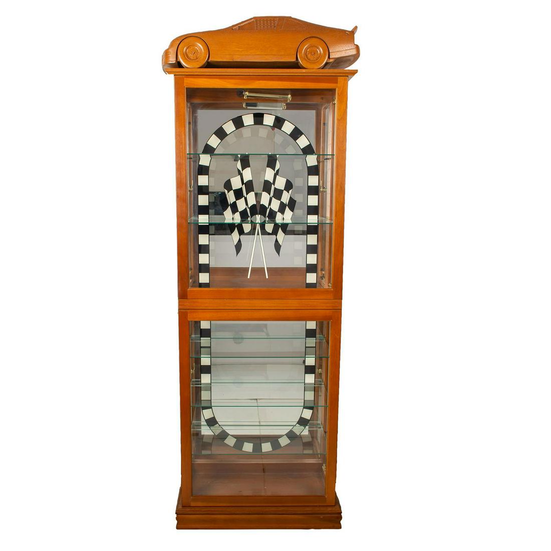 Hand Carved Custom Wood Display Cabinet: Illuminated wood cabinet with carved race car on top mirrored glass on rear. Issued: 20th c. Dimensions: 12"L x 27"W x 73"H Country of Origin: USA