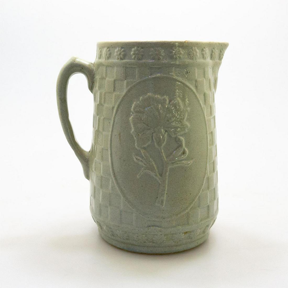 Stoneware Pitcher: Large pitcher with decor of a single flower on a checkered ground. Daisy rim, Issued: 20th century Dimensions: 9.5"H Country of Origin: USA