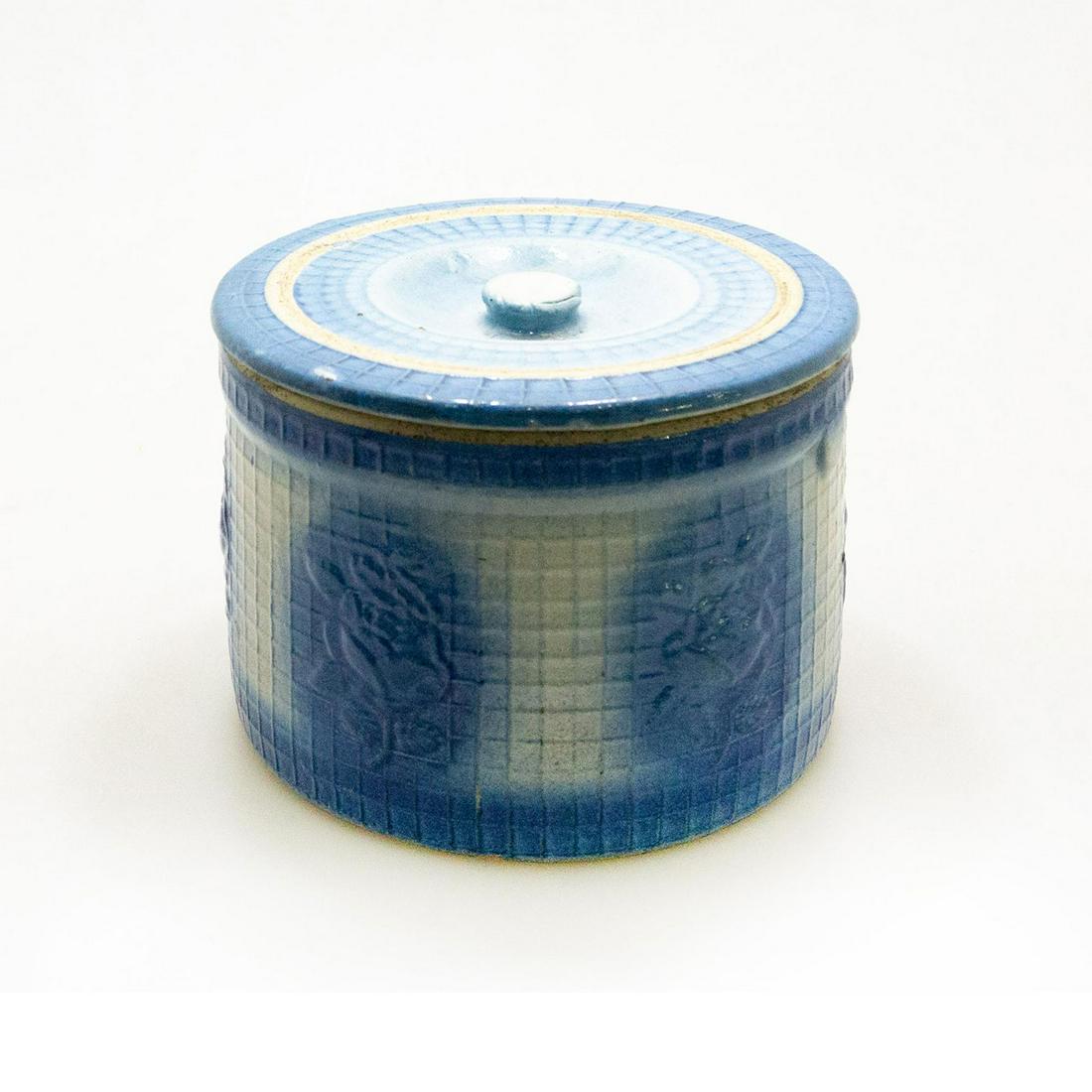Yellow Ware Daisy Trellis Crock: Yellow ware stoneware covered crock in daisy trellis pattern blue and white salt glaze Issued: C. 1930-1940 Dimensions: 5.5H x 7.5" dia. Country of Origin: USA